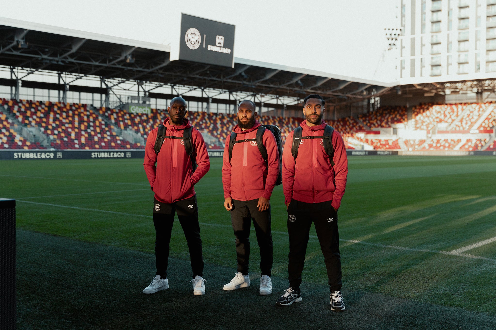 Brentford football players on the pitch with Stubble & Co backpacks