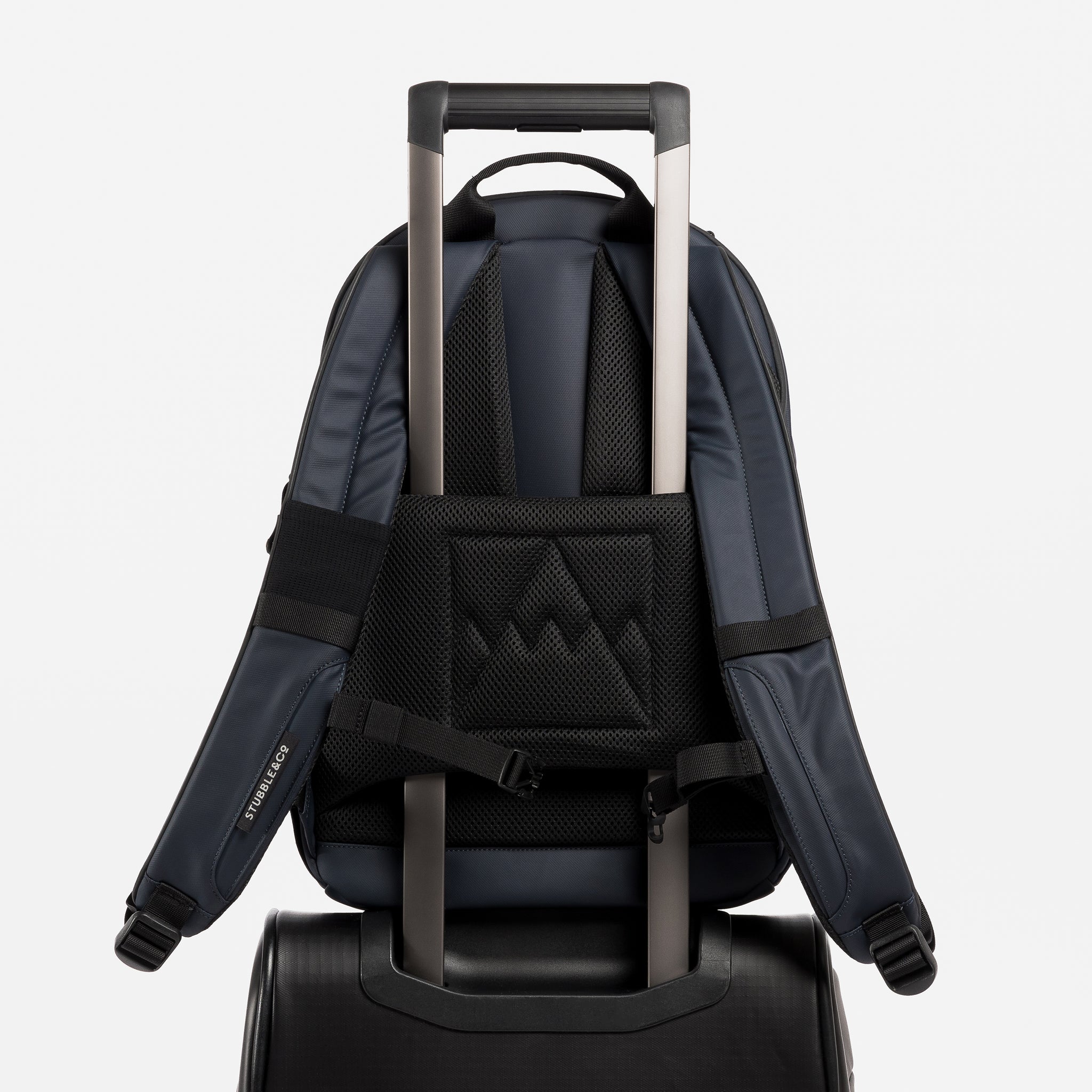 A studio shot of an Everyday Backpack 15L in Midnight Blue showing the luggage sleeve
