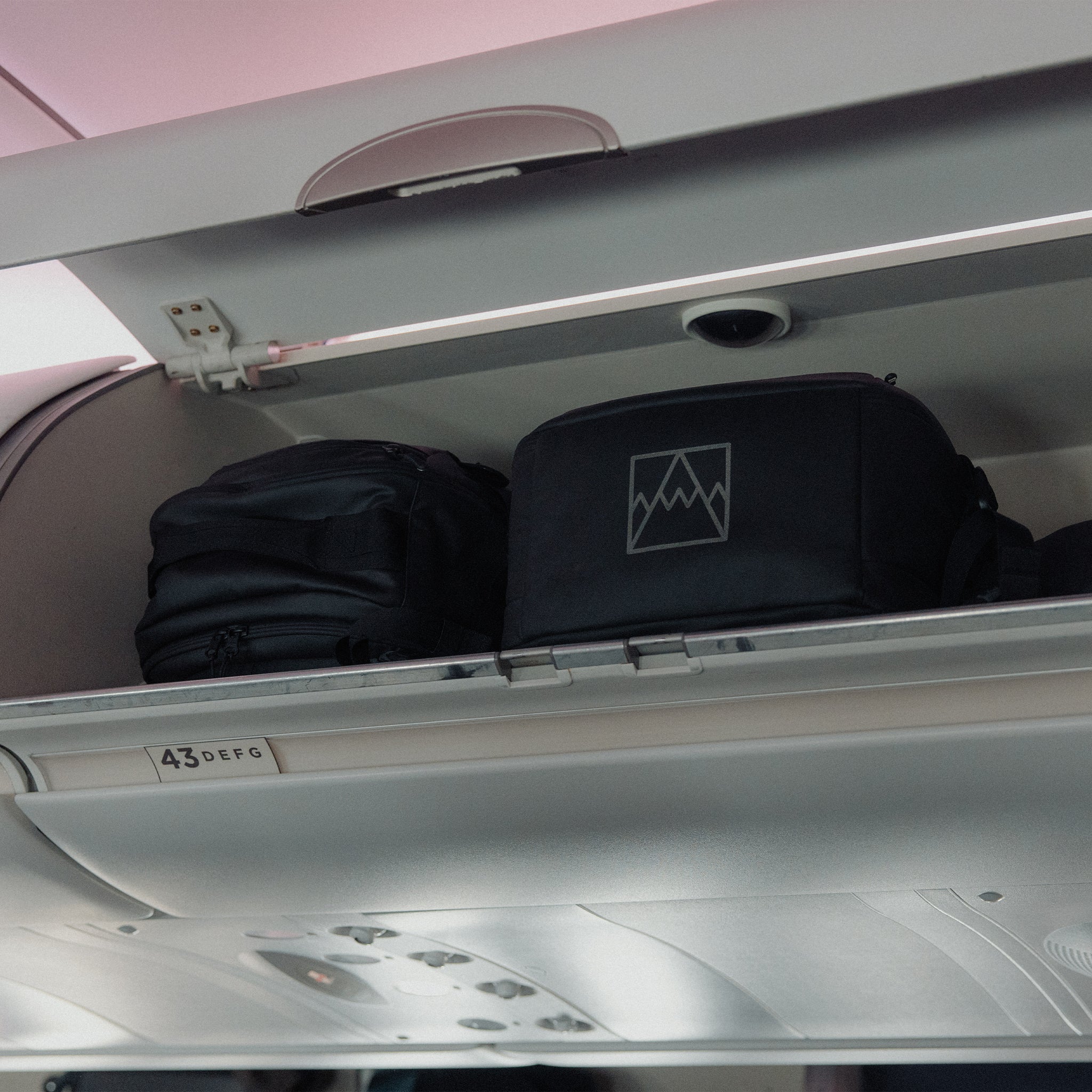 2 Hybrid Backpack 30L in the overhead locker on an airplane