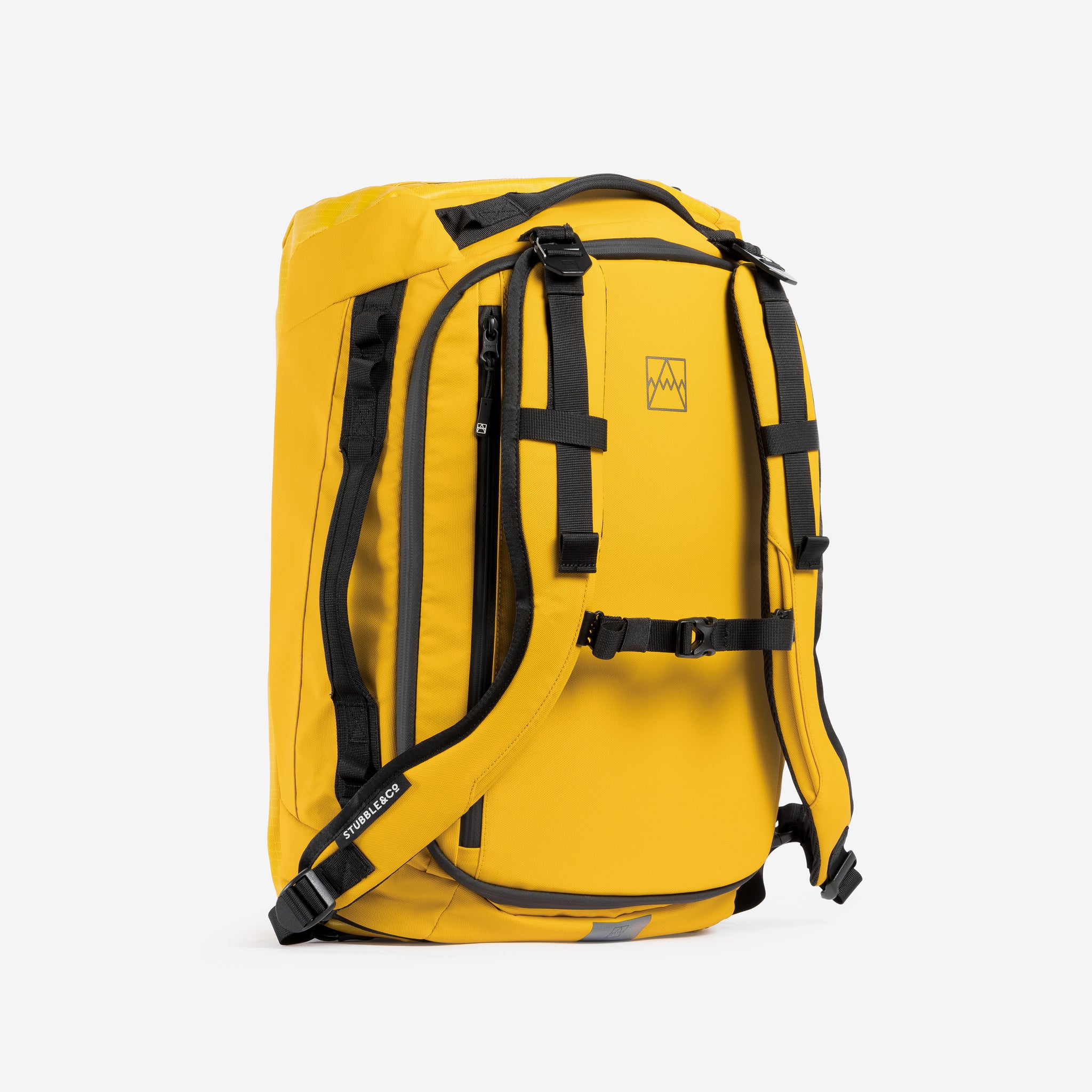 A studio shot of the Kit Bag 30L in Yellow showing the back straps