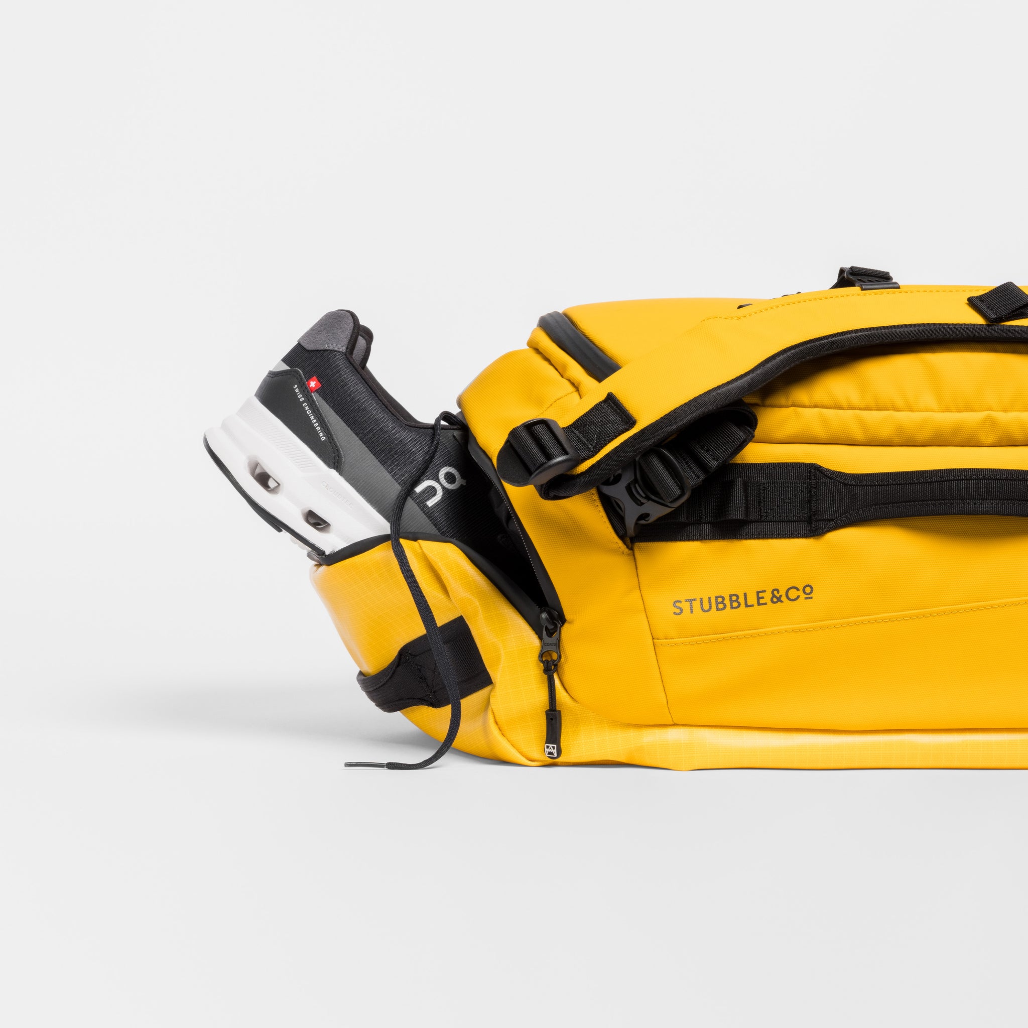 A studio shot of the shoe compartment on the Yellow Kit Bag 30l