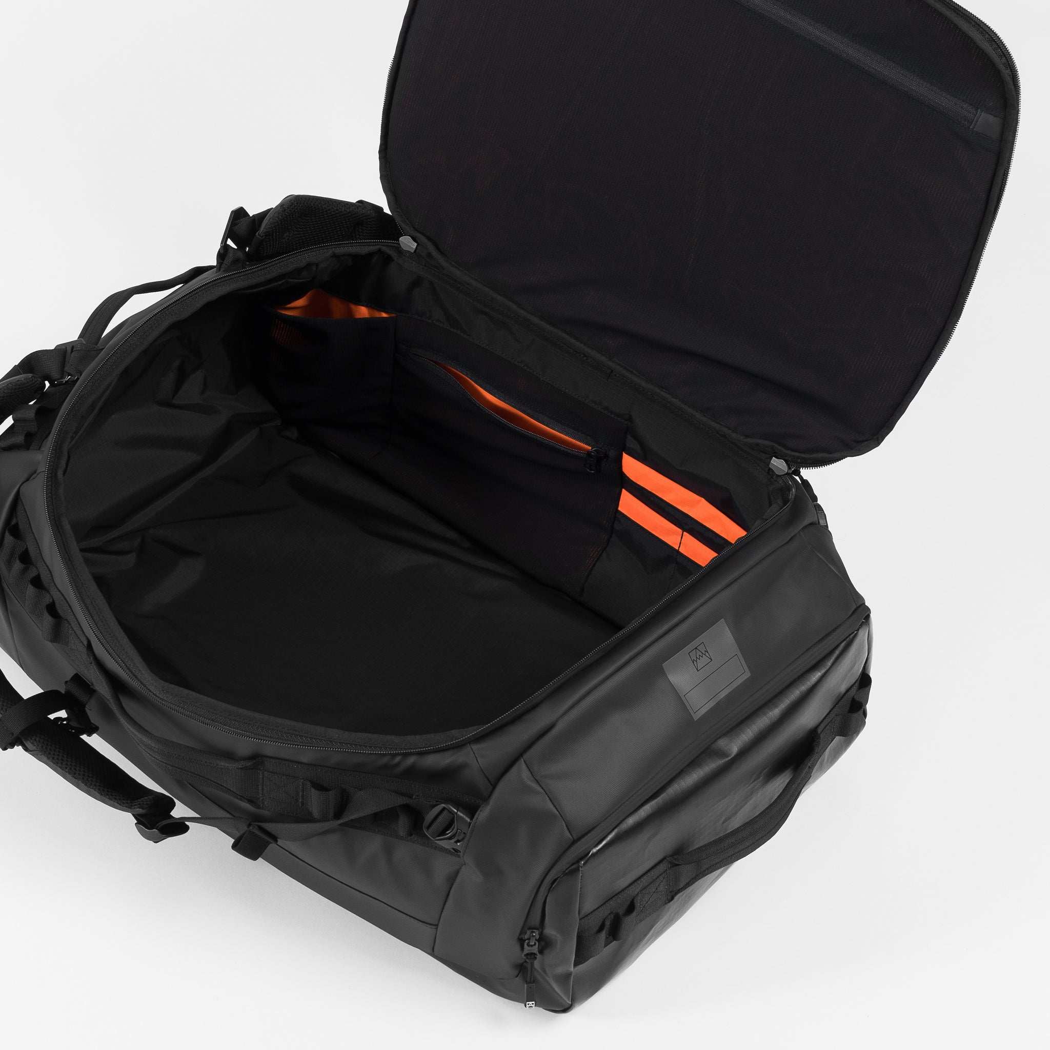 A studio shot of the interior and pockets inside the Kit bag 65L in All Black
