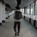 Man wearing The Roll Top 20L Backpack in All Black