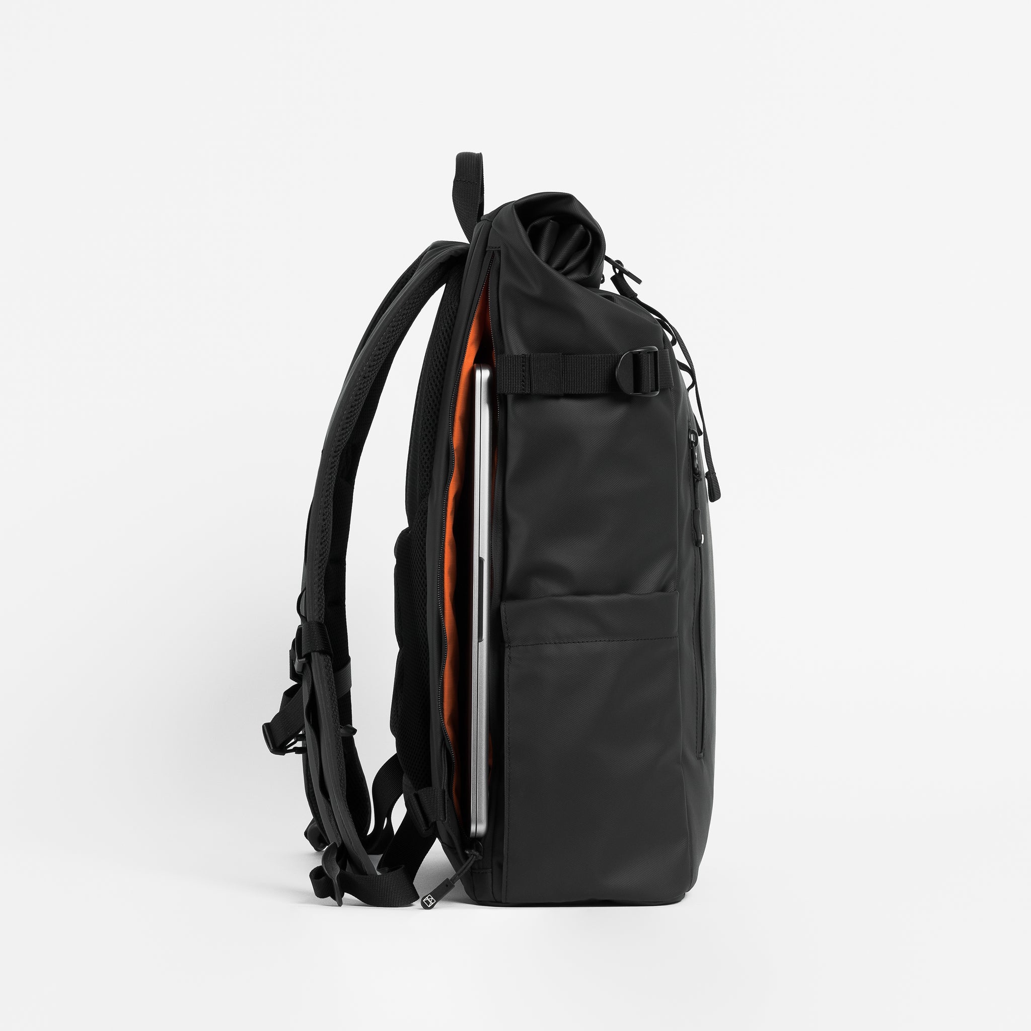 Side view of The Roll Top 20L Backpack in All Black with laptop compartment