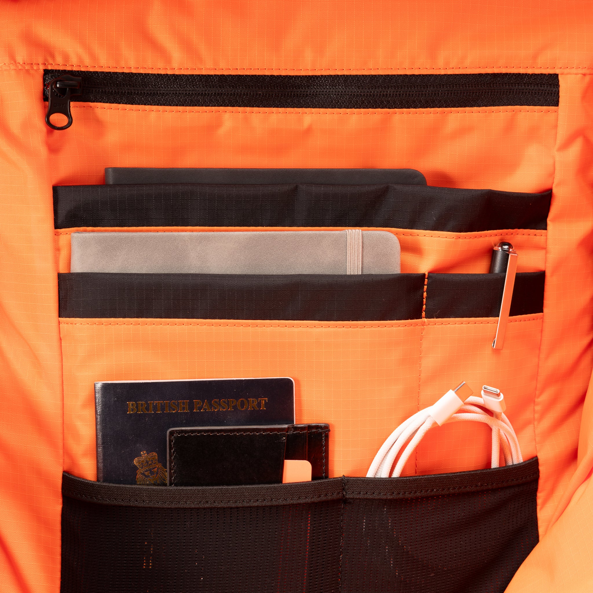 A  studio shot of the Roll Top 30l in Urban Green showing the interior orange lining and organisation