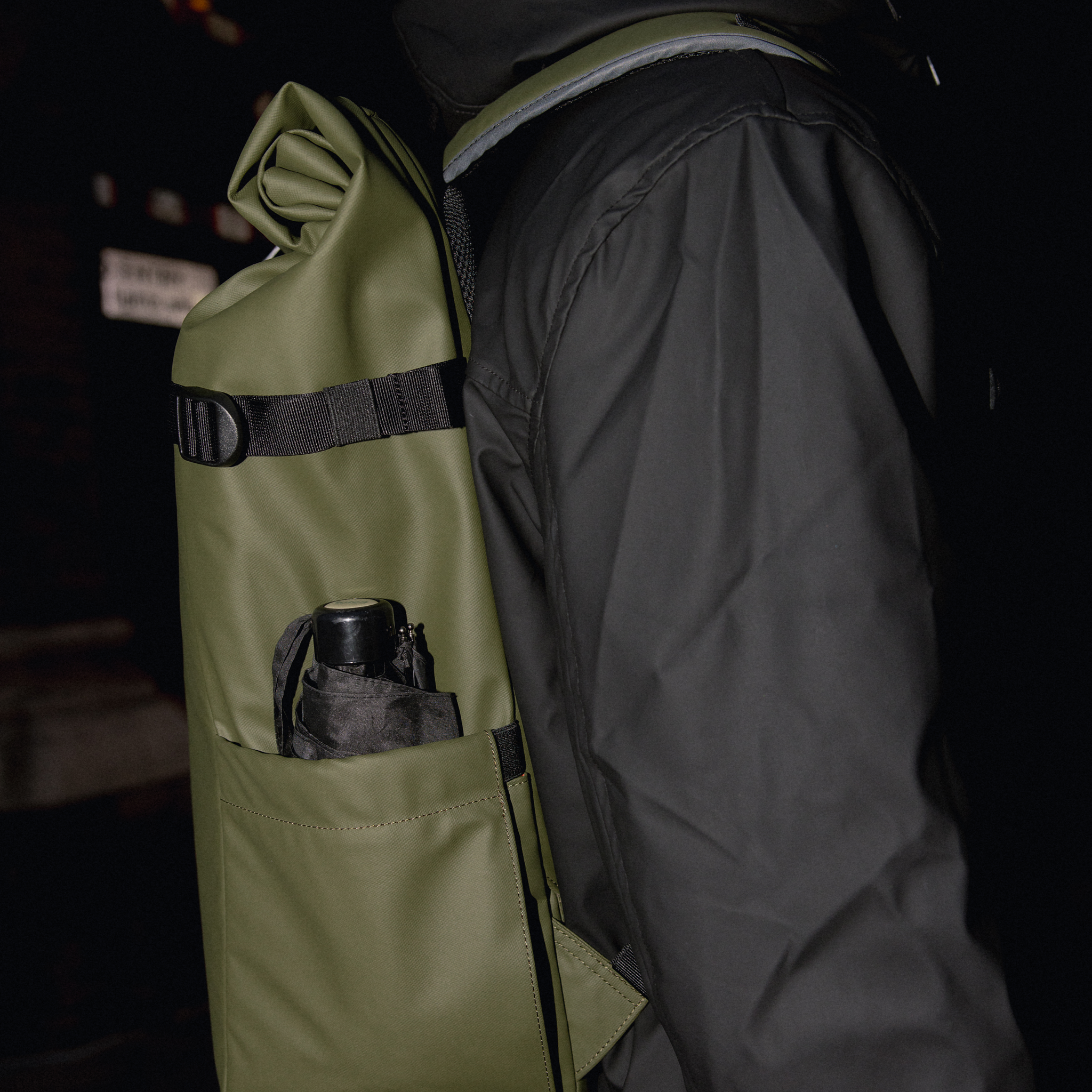 A close up of an umbrella in the external side pocket on an Urban Green Roll Top 30L