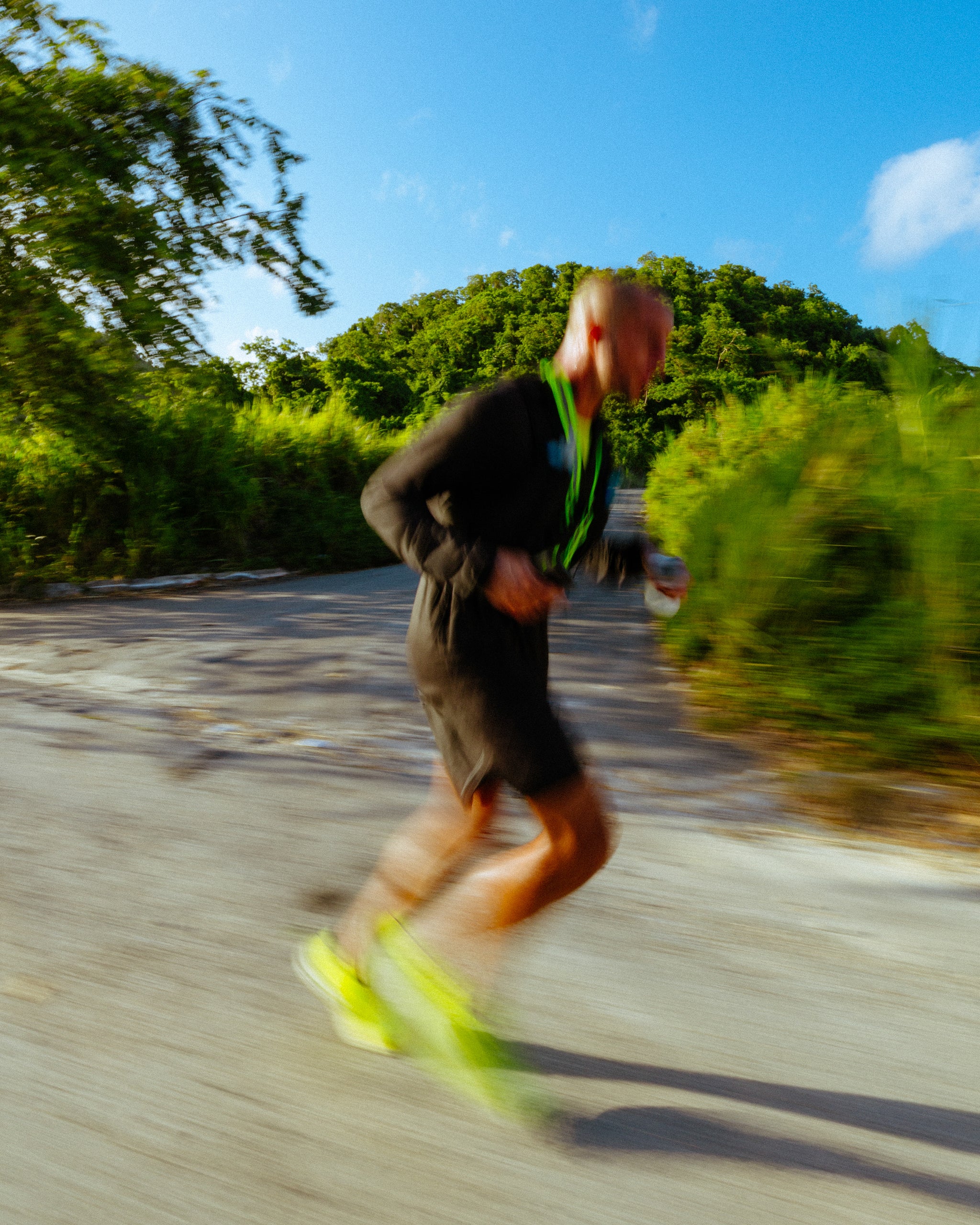 A blurry photo of a man running a long the road