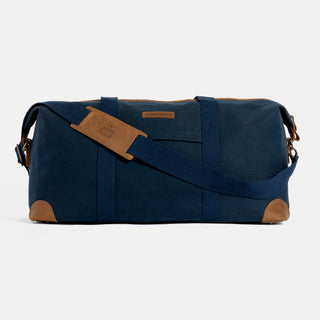Product shot of The Weekender in All Black from the front, with the shoulder strap in front.