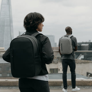 Women with black backpack and man with grey backpack