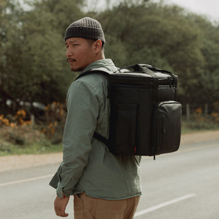 Man wearing cooler backpack in black