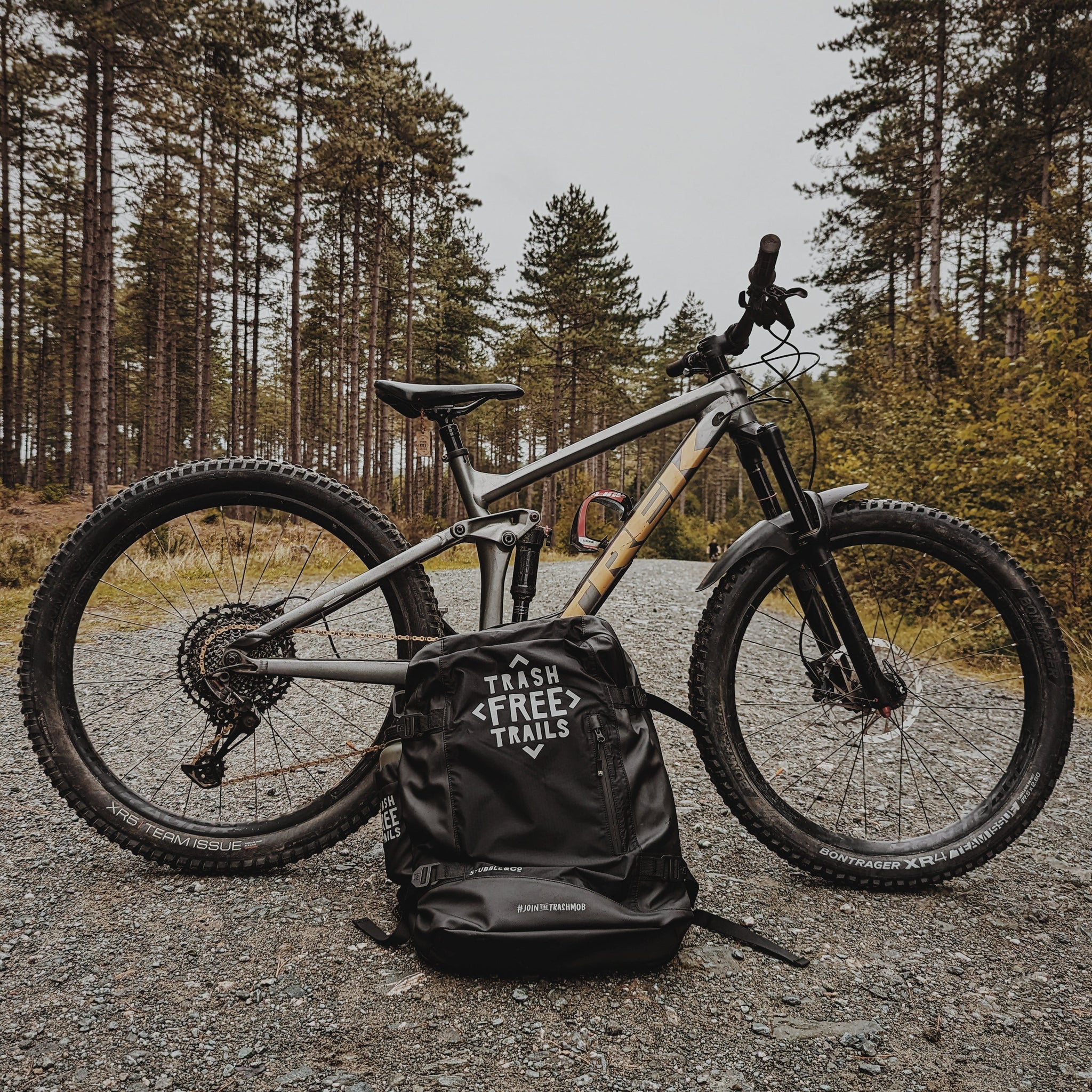 Mountain bike on trail with backpack in front