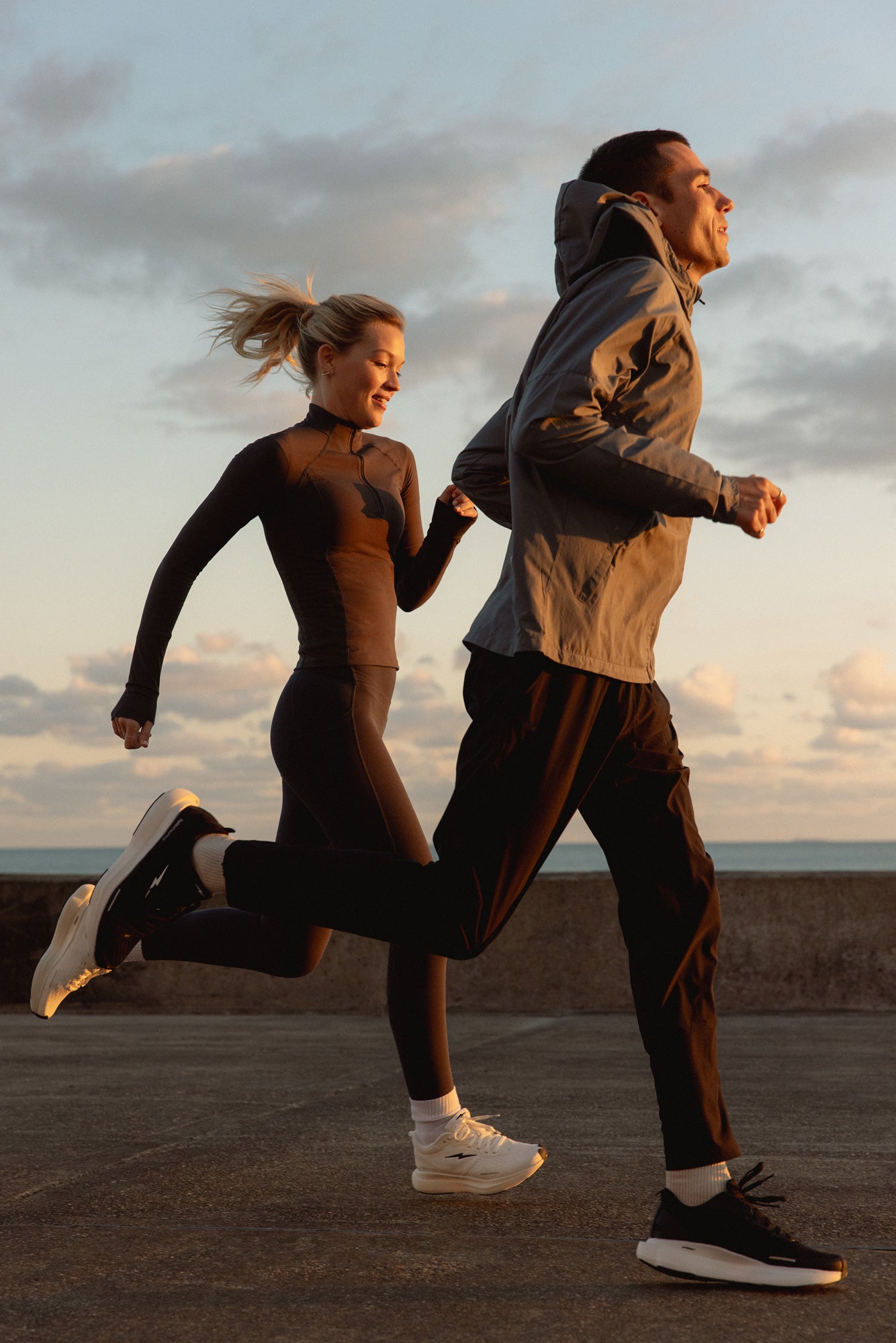 Two people running together on a path with a scenic background