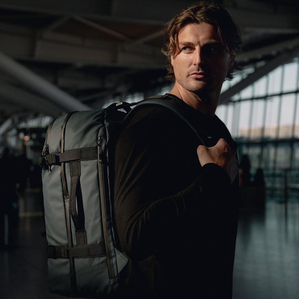 man wearing large adventure bag backpack