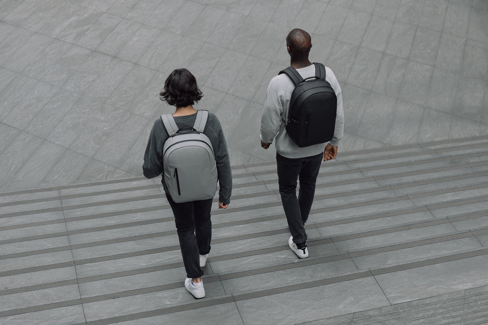 Man and women walking down steps with the Everyday Backpack