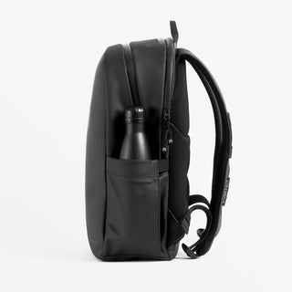 Stubble and Co Everyday Backpack in black side view with bottle