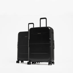 Two black hard-shell spinner suitcases with the larger suitcase in front and a smaller one behind. [All variants]