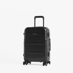 A black hard-shell spinner suitcase with an extended telescoping handle, standing upright against a clean white background.  [All variants]