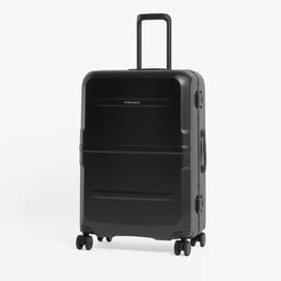 A black hard-shell spinner suitcase with an extended telescoping handle, standing upright against a clean white background. [All variants]