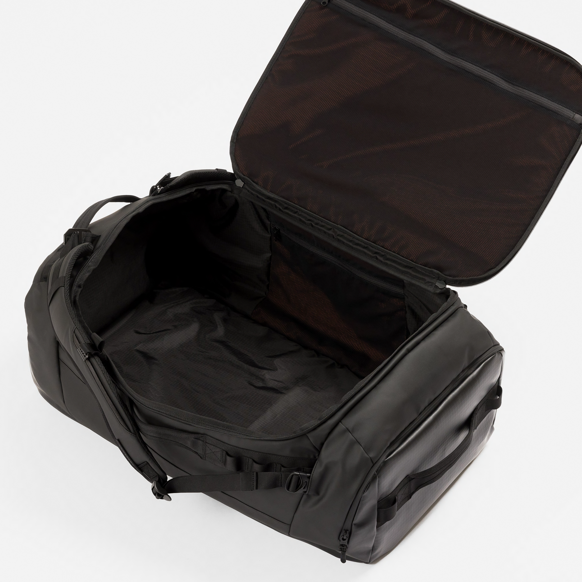 A black duffel bag shown open from an overhead angle, revealing a spacious interior with a zippered compartment and padded handles, photographed on a clean white background.