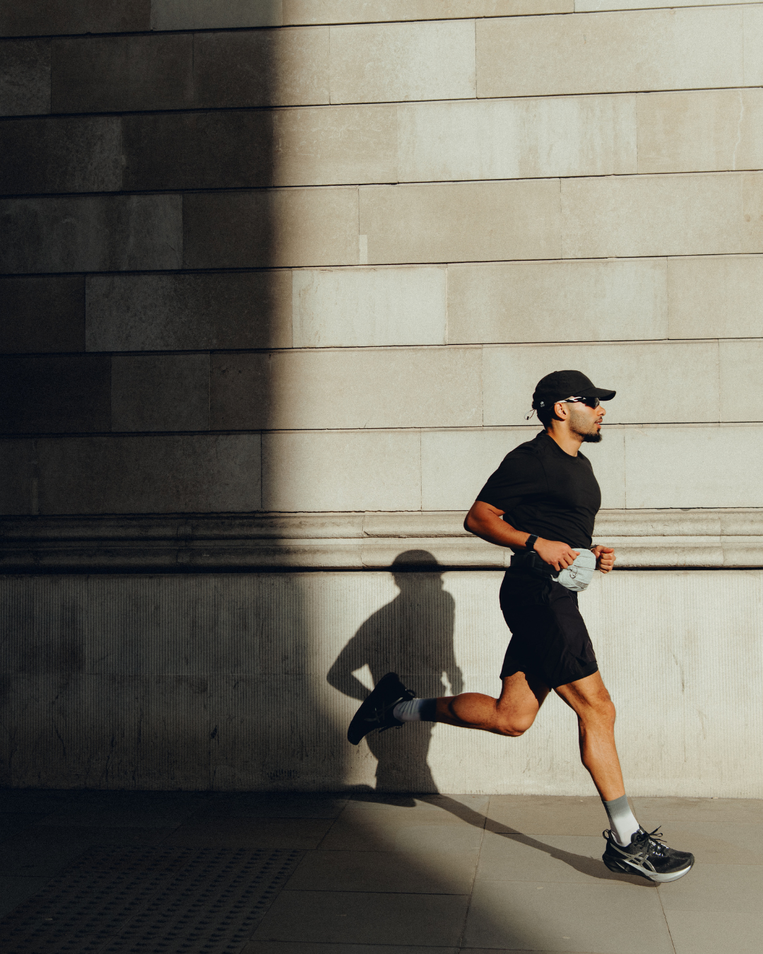 Man running in Bank, London wearing the Stubble & Co Motion Waist Pack