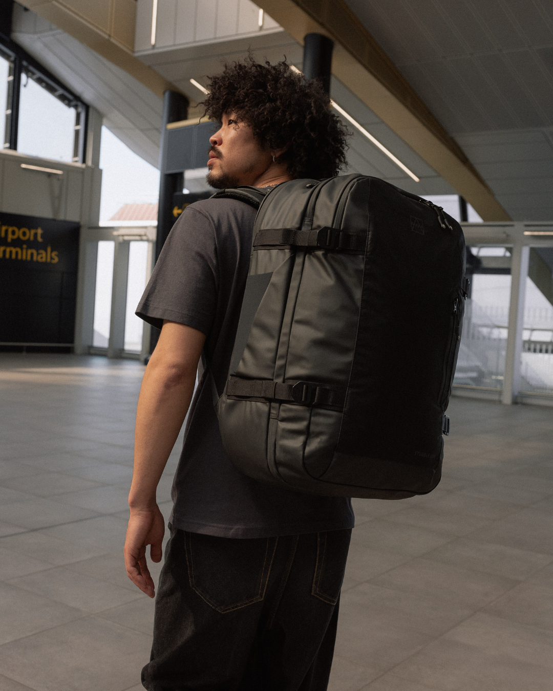Man wearing a travel backpack in airport