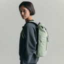 Women wearing the Roll Top Mini Backpack in Matcha green