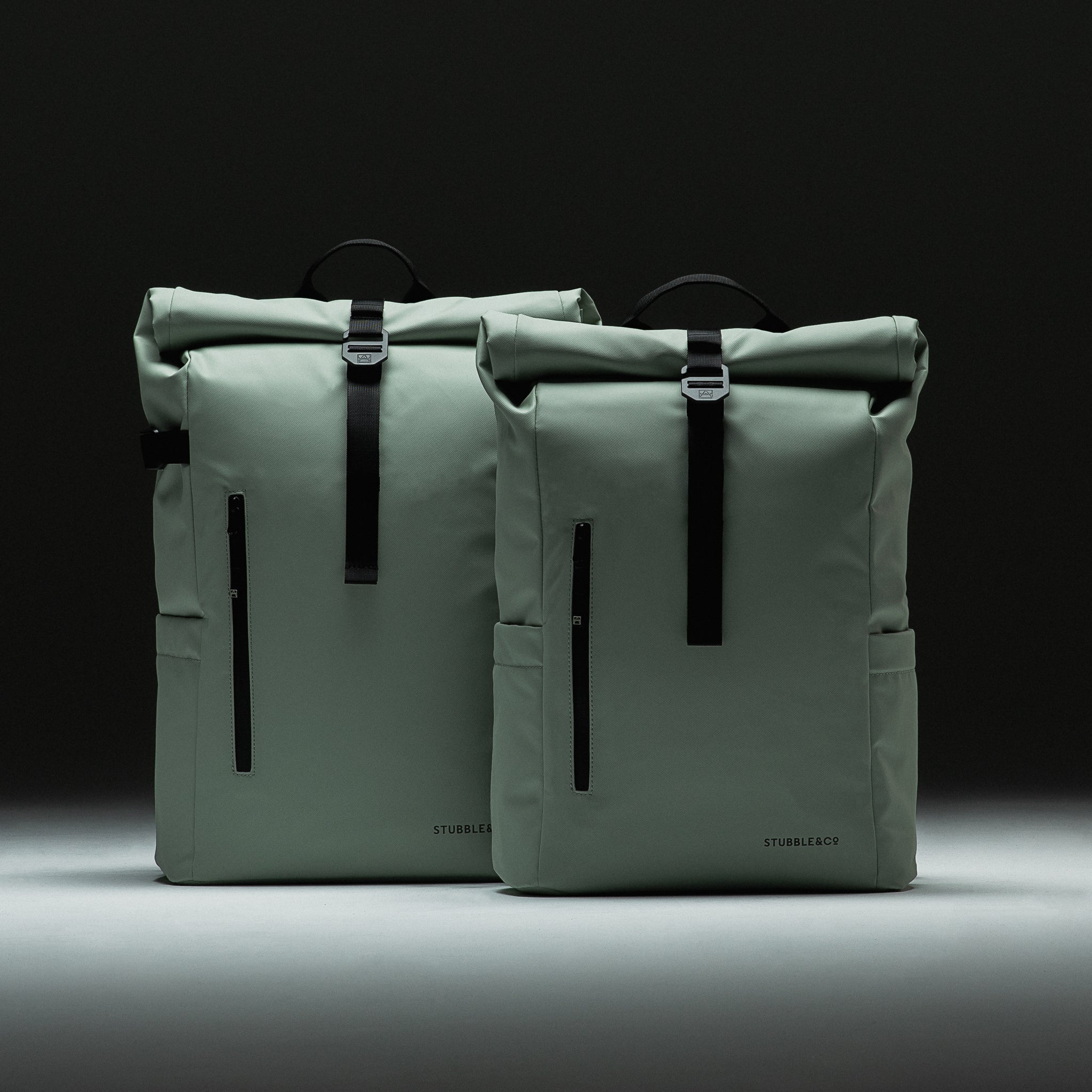 Front view of the Roll Top and Roll Top Mini Backpacks side by side in Matcha green