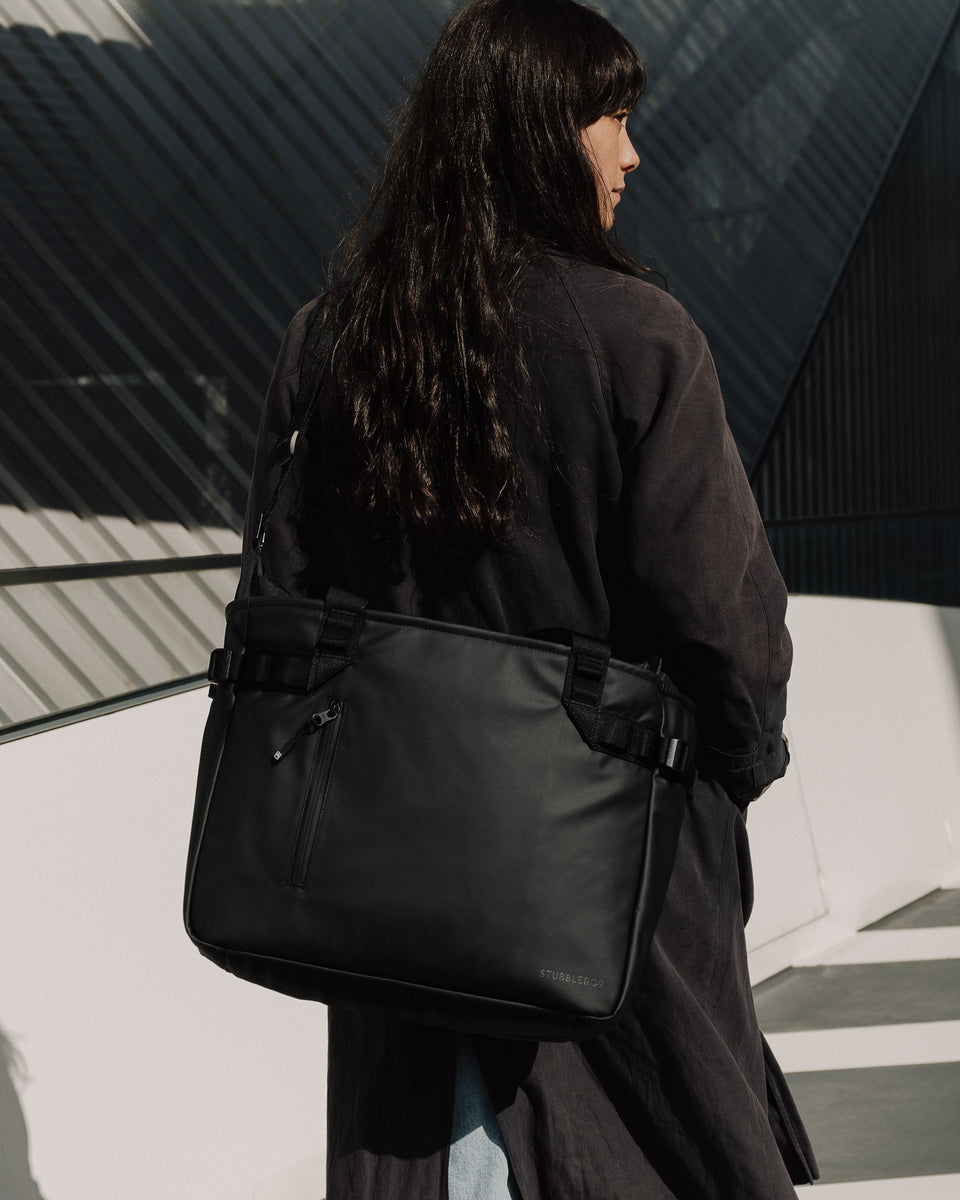 Person carrying a black tote bag