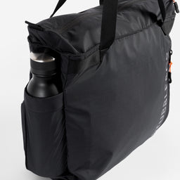 a studio shot of the bottle pocket of a black ultra light tote bag [All variants]