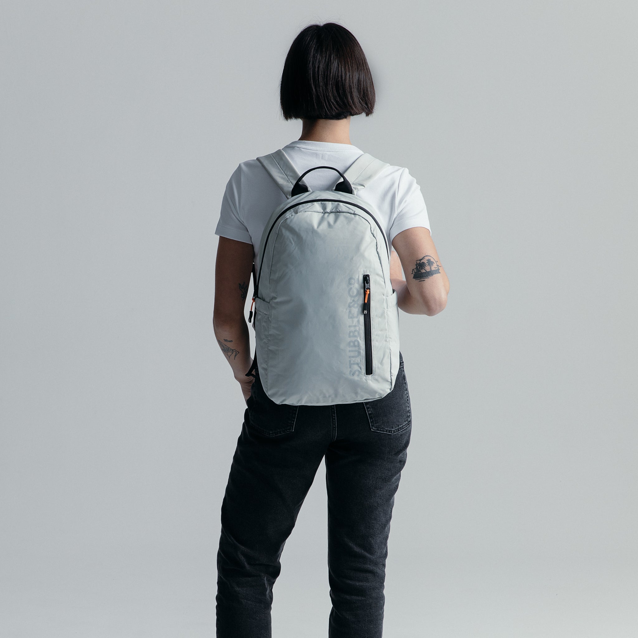 Women wearing the packable Off White Ultra Light Backpack