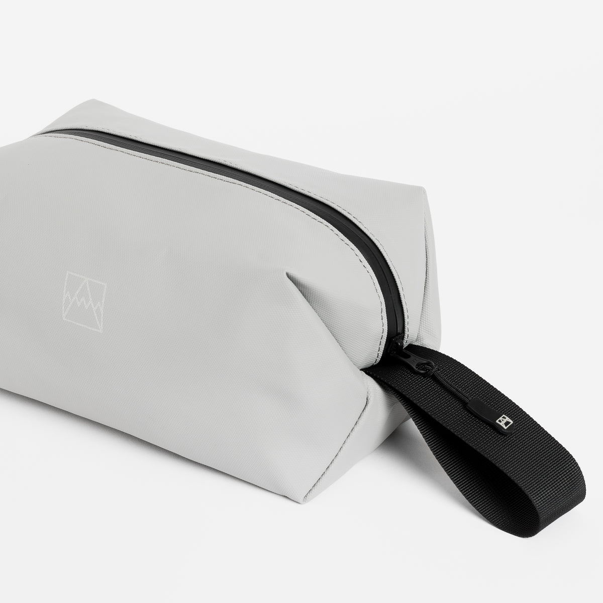 Close-up of the grab handle on the Wash Bag in Concrete