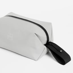 Close-up of the grab handle on the Wash Bag in Concrete
