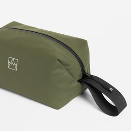 Close-up of the grab handle on the Wash Bag in Urban Green