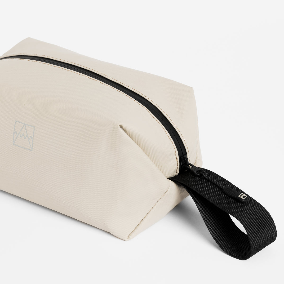 Close-up of the grab handle on the Wash Bag in Sand