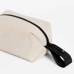 Close-up of the grab handle on the Wash Bag in Sand
