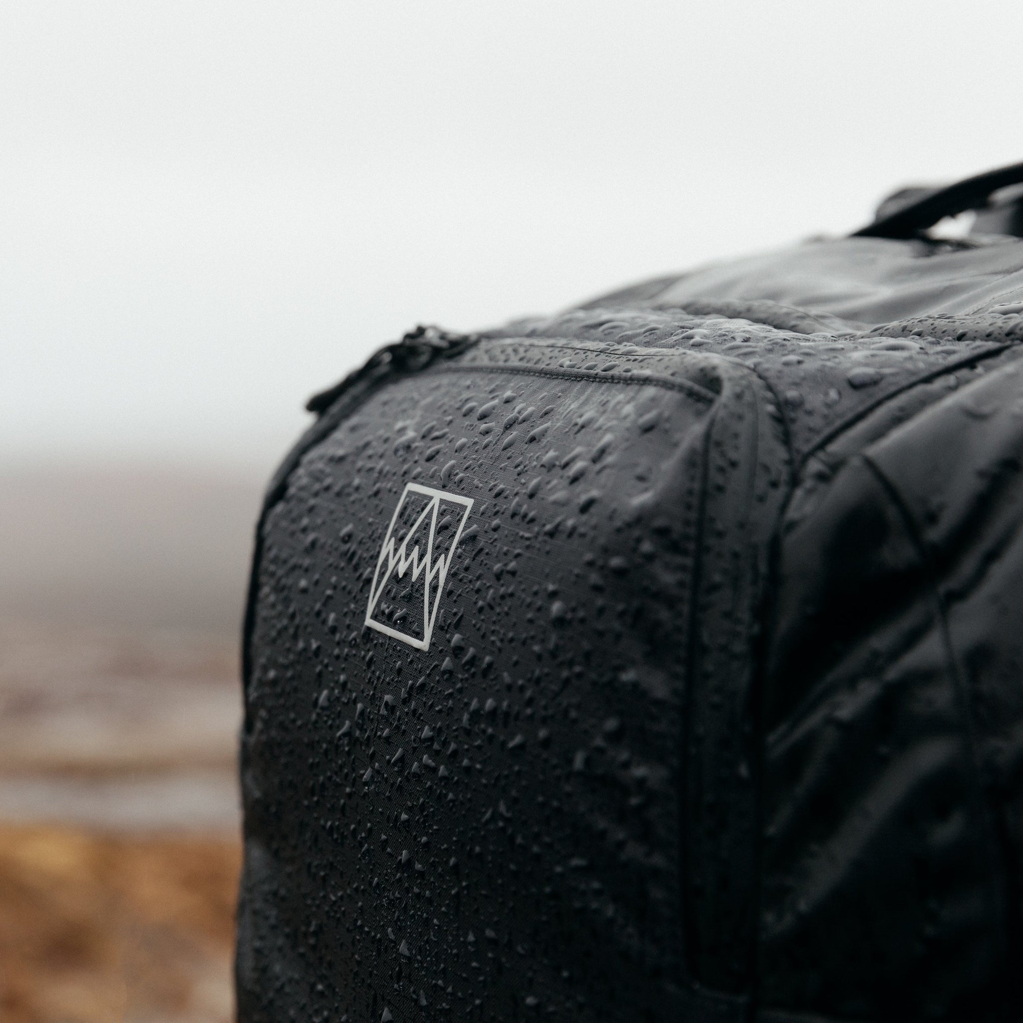 Adventure Bag in black with rain water droplets