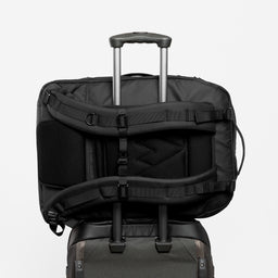 A studio shot of a black adventure bag on a suitcase showing the luggage sleeve [All variants]