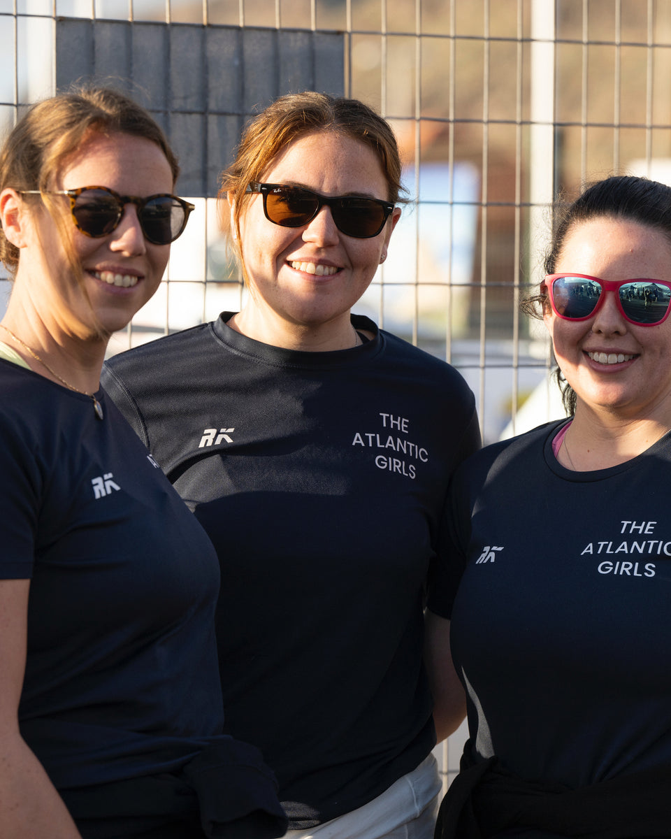 Three girls from the Atlantic Girls group smiling at the camera