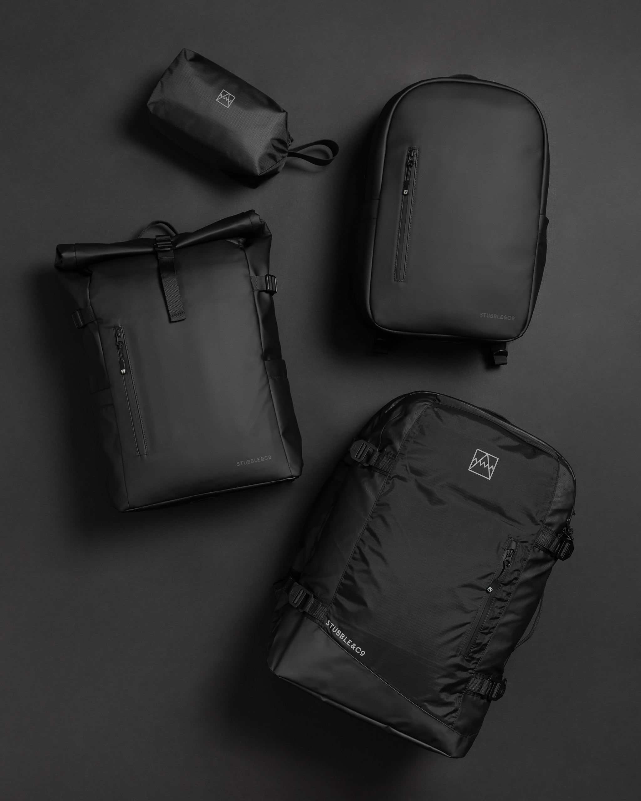 Flat lay of collection of black bags and backpacks