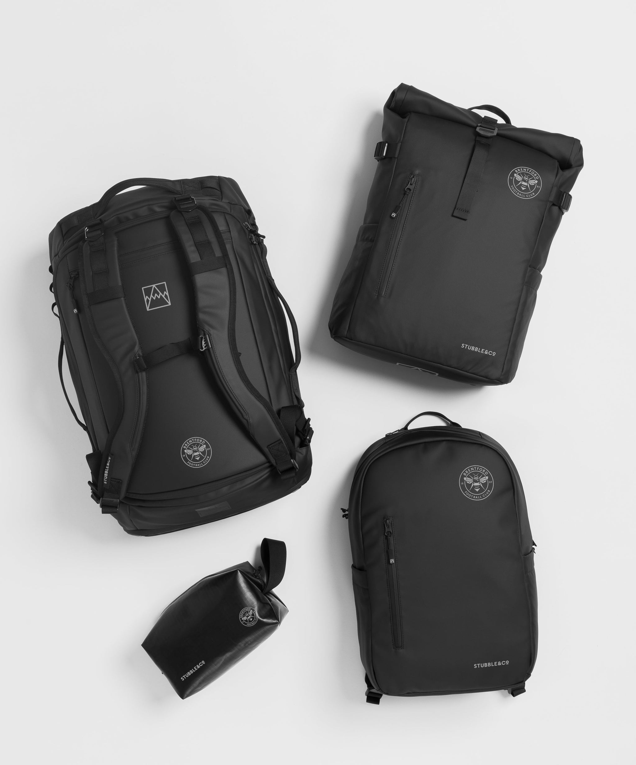 Collection of black backpacks with Brentford FC logo on them