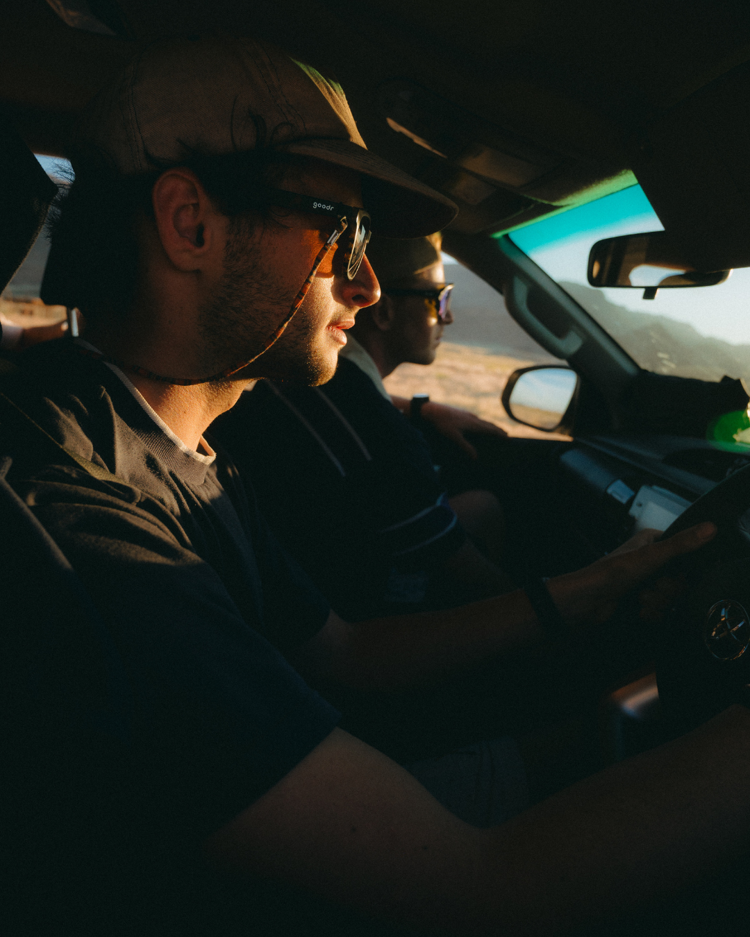 Two men driving truck on road trip in Naimbia