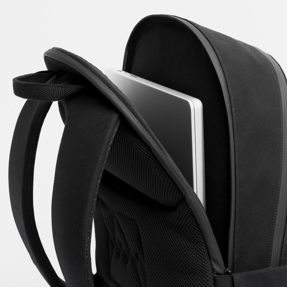 A studio shot of the laptop pocket on the Commuter Backpack 25L in All Black