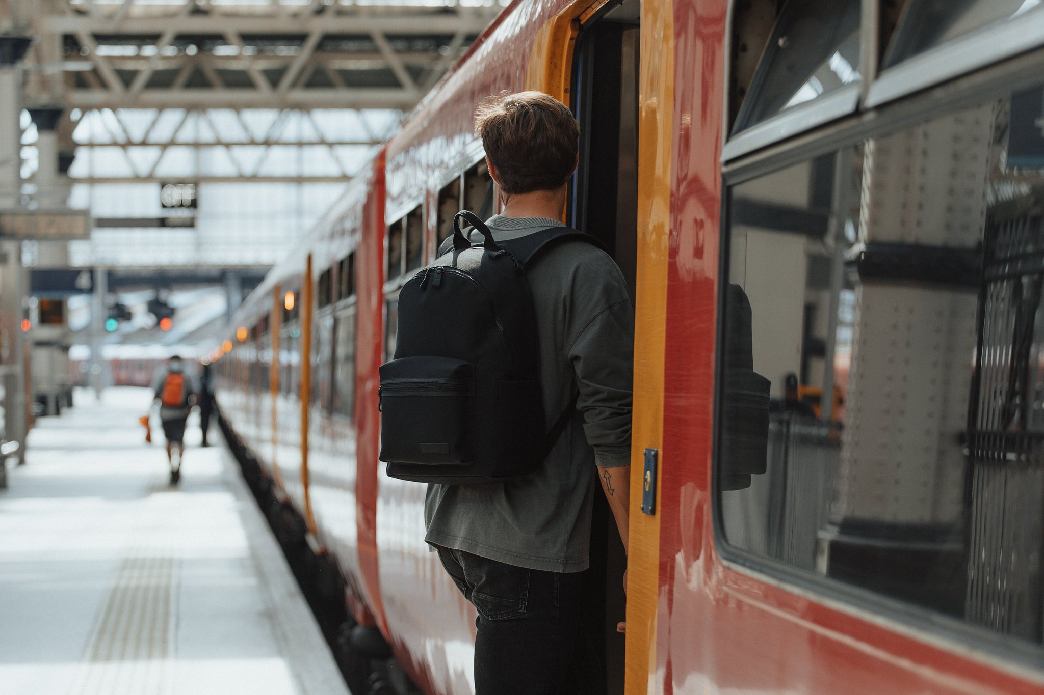 Man with Commuter backpack and train