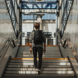 Man wearing The Commuter All Black walking up stairs