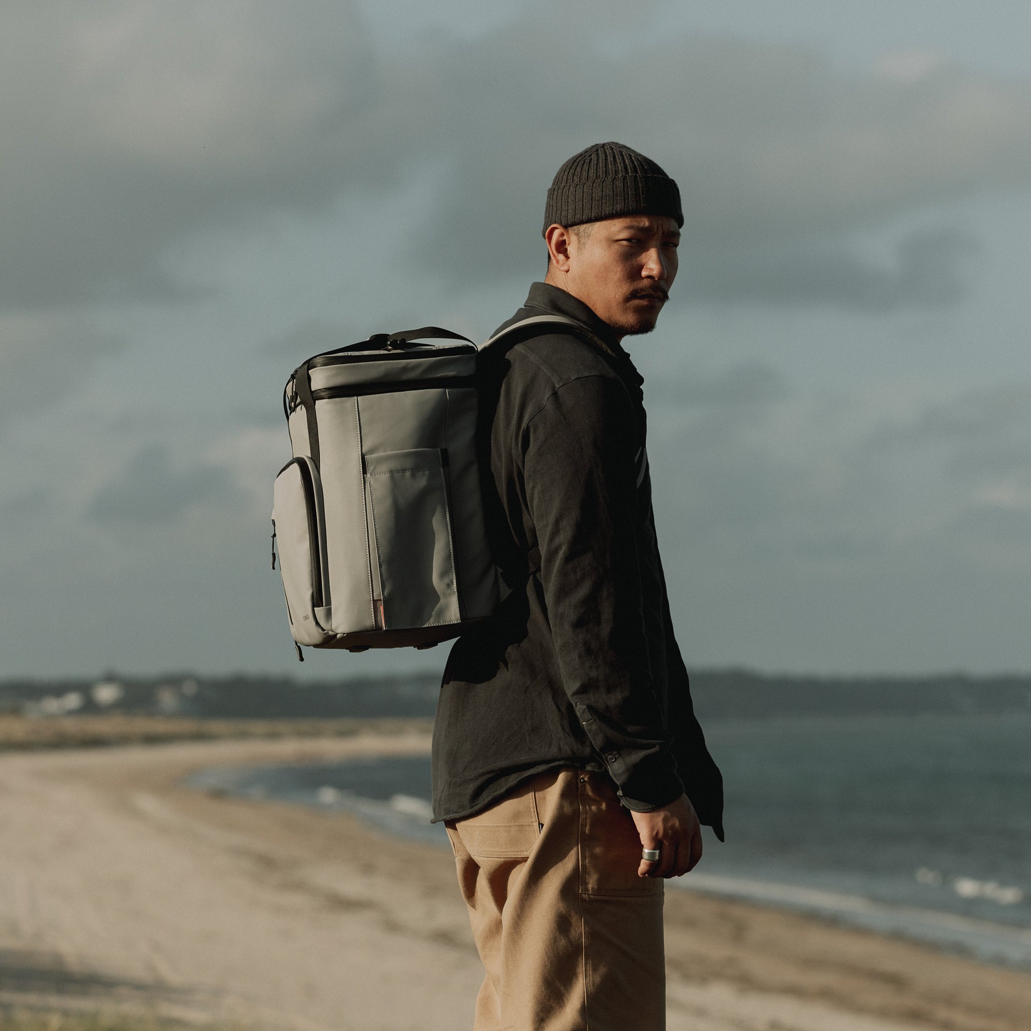 Man wearing The Cooler Backpack in Grey Concrete