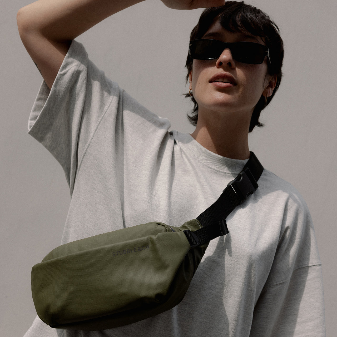 A woman wearing an Urban Green Crossbody 