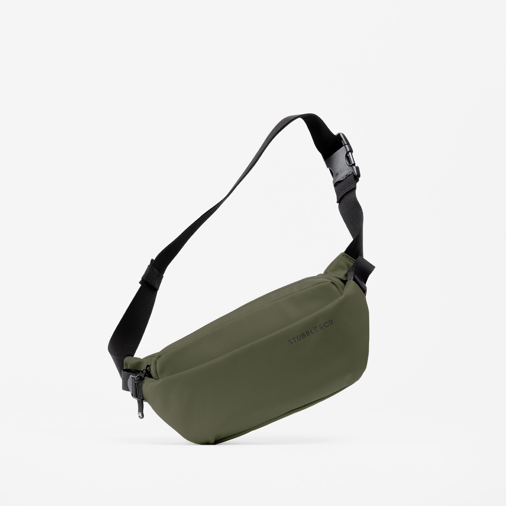A studio shot of an Urban Green Crossbody with its strap hanging up