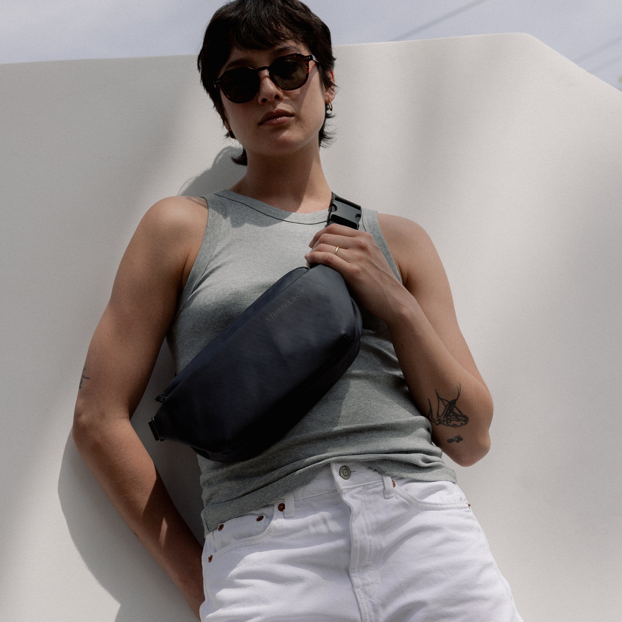 A woman wearing a Midnight Blue Crossbody on her front