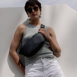 A woman wearing a Midnight Blue Crossbody on her front