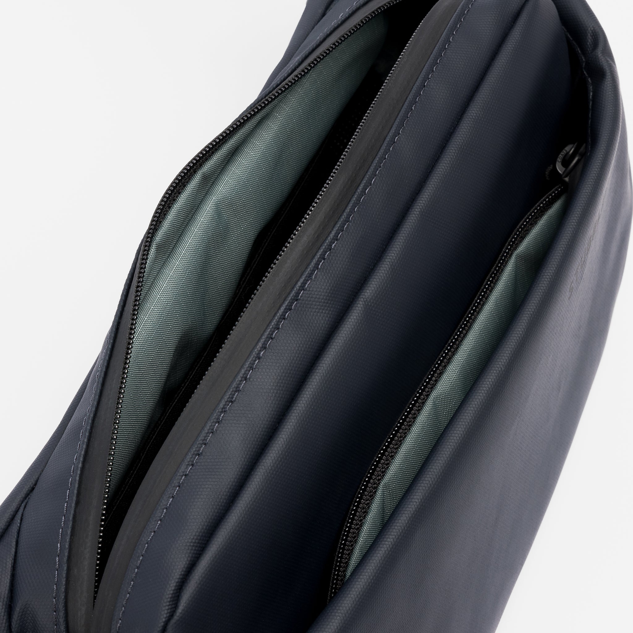 A studio shot of the interior pockets and lining on a Midnight Blue Crossbody